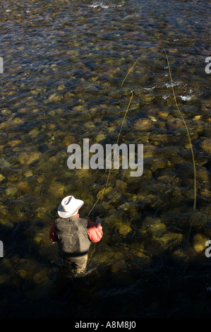 IDAHO SAWTOOTH MOUNTAINS Fly fisherman casting for Rainbow Trout on the main Salmon River near Stanley Id MR Stock Photo