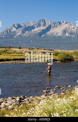 IDAHO SAWTOOTH MOUNTAINS Fly fisherman casting for Rainbow Trout on the main Salmon River near Stanley Id MR Stock Photo