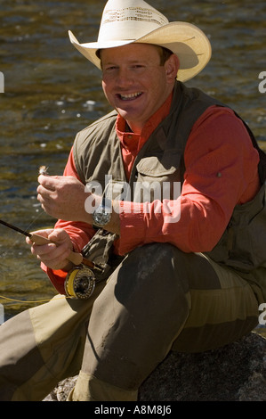 IDAHO SAWTOOTH MOUNTAINS Fly fisherman preparing to fish for Rainbow Trout Main Salmon River Near Stanley Id MR Stock Photo