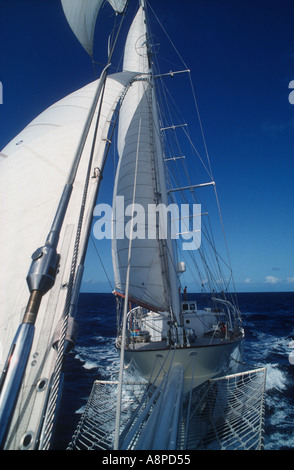 Three masted staysail Schooner Aquarius W from the end of the bowsprit in the Atlantic Ocean Stock Photo