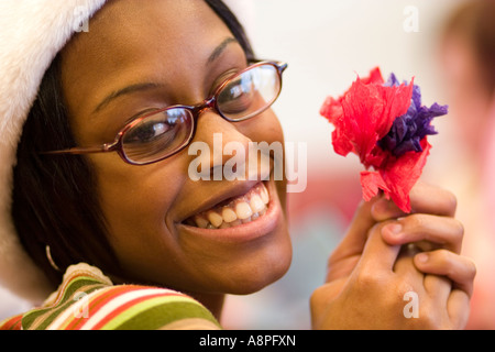 Teen looking happy and holding a flower. St Paul Minnesota USA Stock Photo