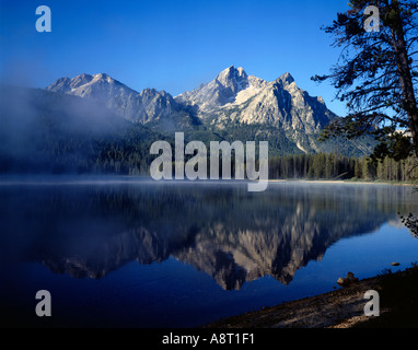 Morning mist rises from Stanley Lake in the Sawtooth National Recreation Area of Idaho Stock Photo