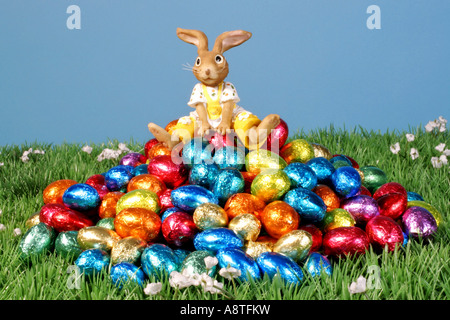 Easter bunny sitting on Easter eggs Stock Photo