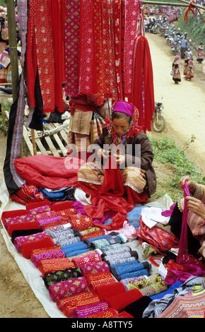 Display of brightly coloured velvet fabric for sale at a stall, at the Saturday market, Can Cau, NW Viet Nam Stock Photo
