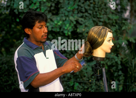 1, one, Mexican man, Mexican, man, wig vendor, selling wig, brushing hair, mannequin head, Chapultepec Park, Mexico City, Federal District, Mexico Stock Photo