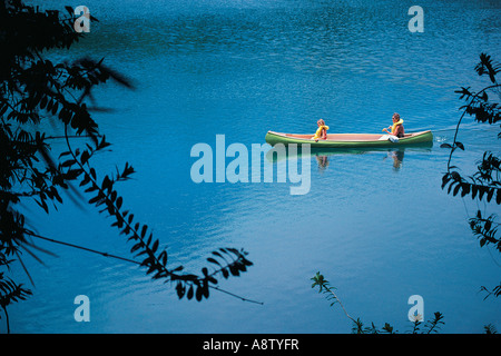 Australia. Queensland. Mother and daughter in canoe on lake. Stock Photo