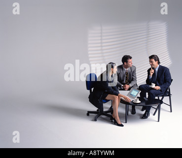 Three business executives meeting in studio setting. Stock Photo