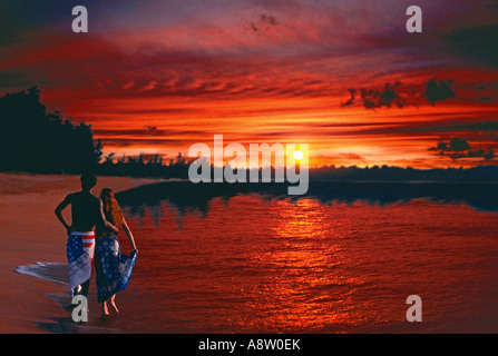 Montage of young couple walking on beach at sunset. Stock Photo