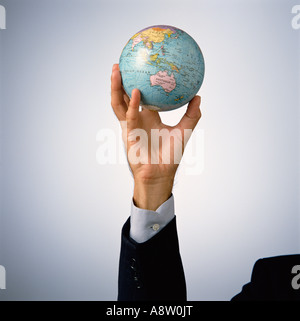 Lifestyle. Business concept. Male hand holding Globe. Stock Photo