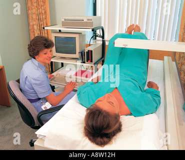 Hospital. Scanning. Diagnostic imaging. Bone densitometry. Female nurse with patient. Stock Photo