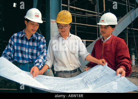 Three men construction site engineers. Guangzhou. China. Stock Photo