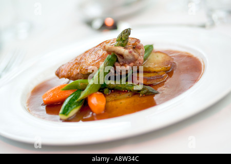 Fine dining, Chicken with asparagus on a white plate Stock Photo