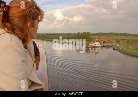Female passenger on cruise ship Ocean Monarch, Kiel Canal, Germany Stock Photo