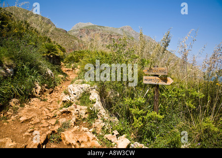 Wooden trail signs point to North and South entrances Zingaro Nature Reserve Scopello Sicily Italy Stock Photo