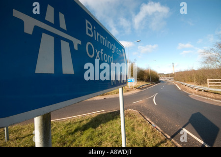 Close up shot of motorway sign post with the road in the background Stock Photo