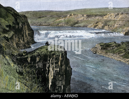 Bison on a bluff overlooking the Great Falls of the Missouri River near its headwaters in Montana. Hand-colored woodcut Stock Photo