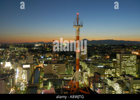 Night settles over Yokohama with Mt. Fuji San in the far background, Kanto JP Stock Photo