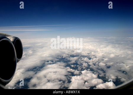 View out of Aircraft Window above the clouds jet  plane Stock Photo