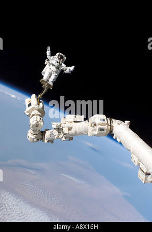 Astronaut Stephen K Robinson anchored to a foot restraint on the International Space Stations Canadarm2