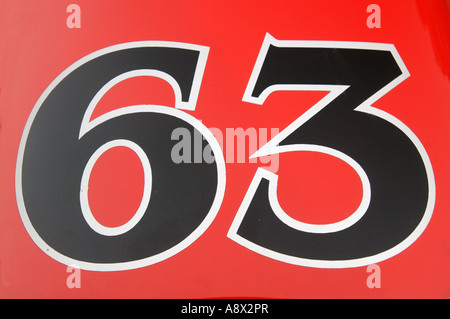 Restored dirt track race car in bright red with number 63 emblazoned on the tail Stock Photo