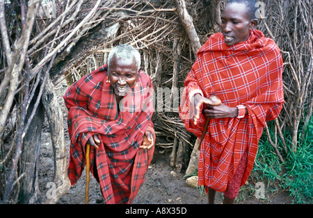 KENYA Masai Mara National Reserve Chief and his son outside the thorn bushes used around their traditional manyatta village as Stock Photo