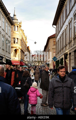 People jostling for elbow space in the narrow streets of picturesque city district of Haga the oldest part of Gothenburg Sweden Stock Photo