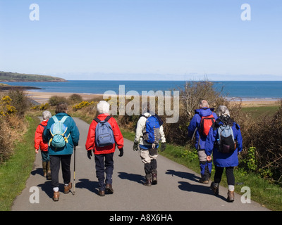 Ynys Mon Ramblers Group of older adult walkers walking along a country lane on the Isle of Anglesey North Wales UK Britain Stock Photo