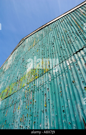 A corrugated iron sheet building with a blue sky. Stock Photo