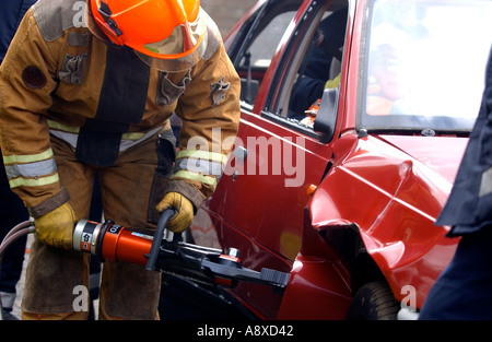 Firefighters cut open a car during a training drill Stock Photo