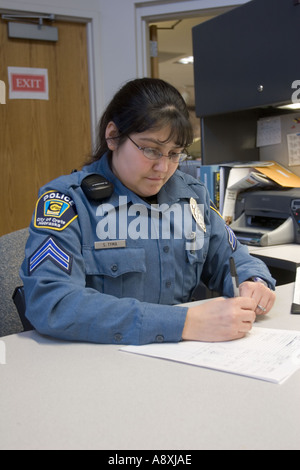 Female police officer using PDA hand held computer Crete Police ...
