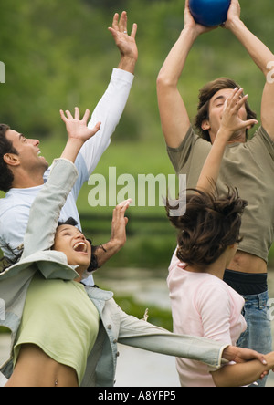 Group of young adult friends playing with ball Stock Photo
