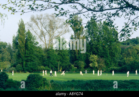 Local cricket teams play in riverside meadow in the town of Winchester, Hampshire, England, UK. Stock Photo