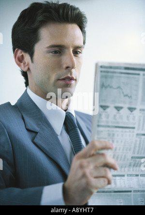 Businessman reading newspaper Stock Photo