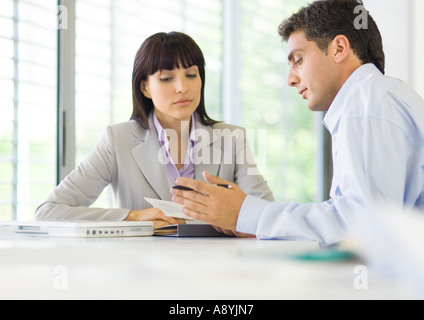 Man and woman having discussion in office Stock Photo