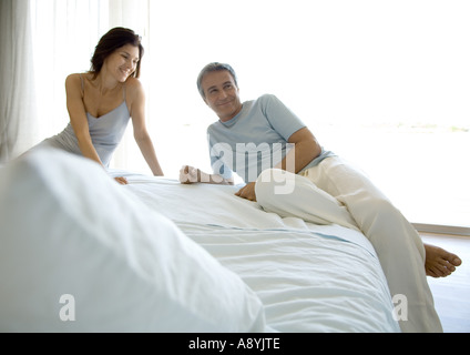 Couple lounging on bed Stock Photo