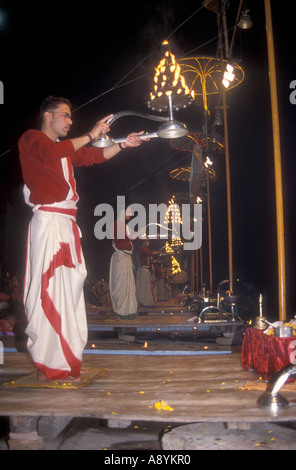 Hindu priests performing the Deepmala Ceremony at a Ghat on the banks of the river Ganges in Varanasi India Stock Photo