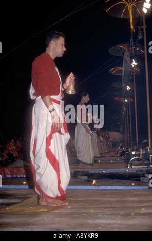 Hindu priests performing the Deepmala Ceremony at a Ghat on the banks of the river Ganges in Varanasi India Stock Photo