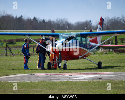 Skydivers gathering round their Cessna aeroplane before takeoff Seppe airfield Noord Brabant the Netherlands Stock Photo