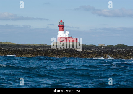 Longstone lighthouse of the coast of Northumbria in a choppy sea against a cloudy sky Stock Photo