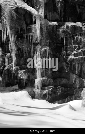 Icicle and snow covered rock face in Yosemite Stock Photo