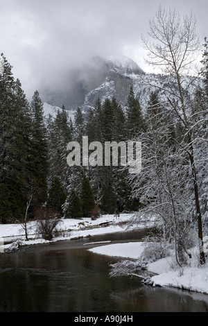 Snowy covered banks of Merced River in Yosemite National Park Stock Photo