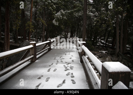 snow covered foot bridge over Yosemite Creek Stock Photo