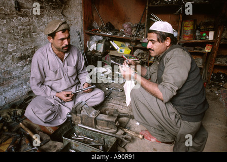 Pakistan NWFP Darra Adam Khel men making rifle bolts Stock Photo