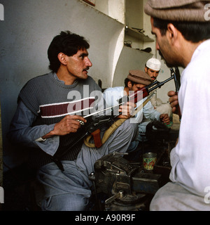 Pakistan NWFP Darra Adam Khel maker inserting bolt into AK47 Kalashnikov barrel Stock Photo