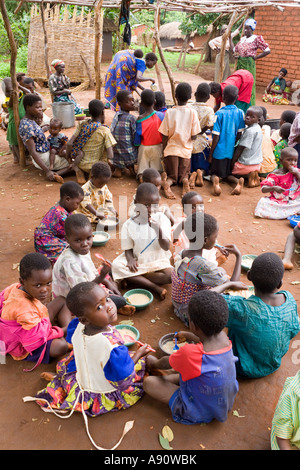 Children eating phala (maize porridge) as part of the Joseph Project feeding programme in the village of Kendekeza Malawi Africa Stock Photo