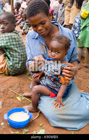 Baby eating phala (maize porridge) as part of the Joseph Project feeding programme in the village of Kendekeza, Malawi, Africa Stock Photo