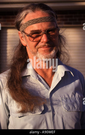 Portrait of a middle aged man smiling with long hair in Australia Stock Photo
