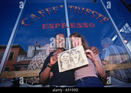 Caffe Trieste North Beach San Francisco CA Inter racial Couple Shows Charcoal Sketch Done For Them By Artist Inside Coffee H Stock Photo