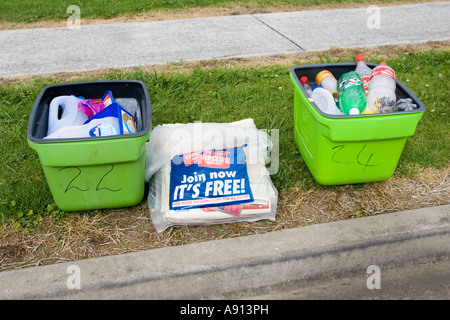 Green recycling bins with plastic bottles awaiting collection Auckland North Island New Zealand Stock Photo