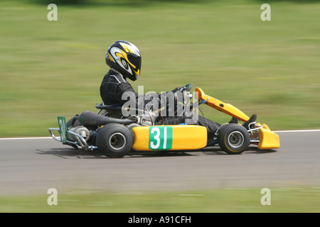 The side view of a speeding yellow gearbox go kart Stock Photo
